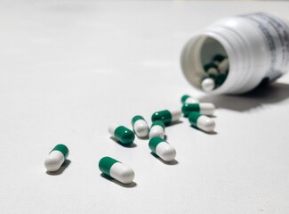 Green and white medicine capsules