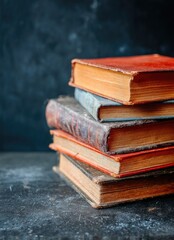 Stack of aged books on dark surface