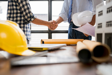 Architects shaking hands after successful meeting in office