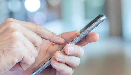 A businessman in an office uses his finger to touch the screen of a tablet computer