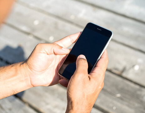 A businessman in an office uses his finger to touch the screen of a tablet computer