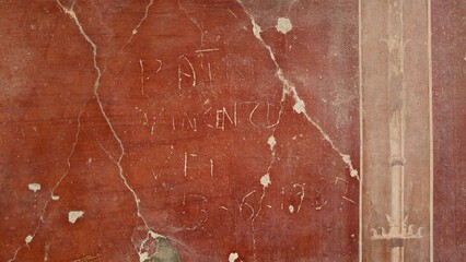 Herculaneum, Italy - 9 January 2025. Scratched graffiti reading “Vincenzo” and dated 5-6-1938...