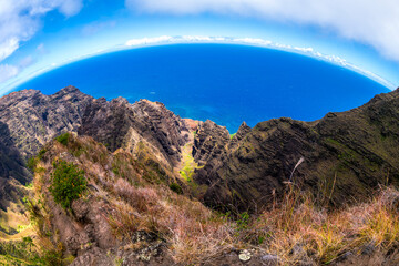Dramatic aerial view of the rugged Na Pali Coast on Kauai, Hawaii, with steep cliffs dropping into...