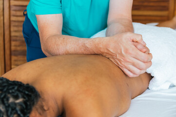 A man is massaging a woman's back