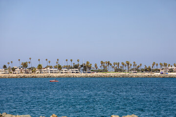 View from the Quivira Jetty. People on an inflatable motor dinghy on channel entrance to the Mission Bay water in southern California.