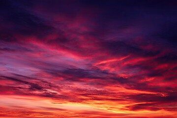 Dramatic sunset cloudscape.  Fiery hues of red, orange, and purple fill a cloudy sky