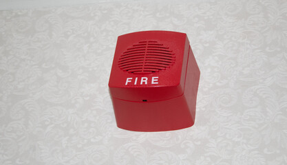 A red fire alarm box mounted on the wall for safety.