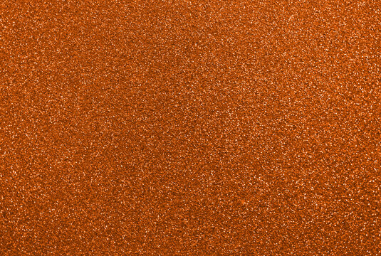 Orange glitter background, shiny sparkling glitter particles creating a beautiful textured effect for website, marketing and social media, abstract sparkles, flame red and rust colored sequins