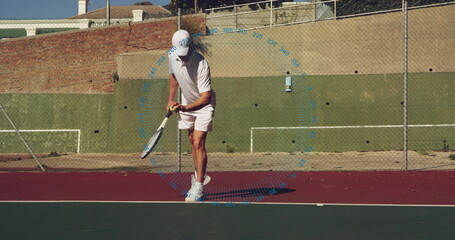 Bouncing tennis player wearing white outfit holding racket and ball on tennis court, with fence