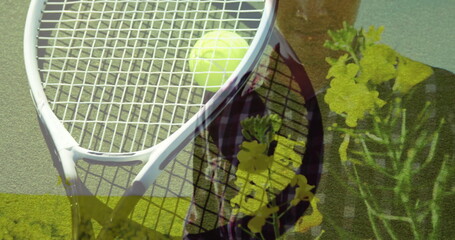 Displaying white tennis racket with yellow ball on tennis court, showing flower overlay, copy space