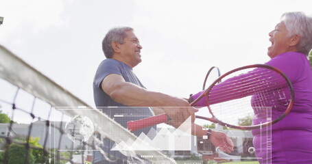 Shaking hands senior tennis couple greeting on tennis court, with rackets and net