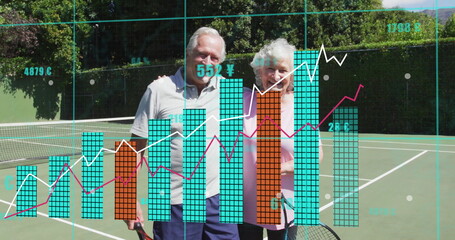 Smiling senior couple leaning together and holding tennis rackets on green court, with data overlay