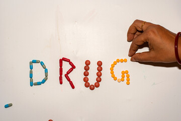 Drug Text with Medicine Pills on White Background for Modern Healthcare Concept