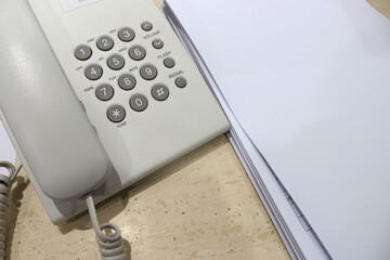 photo of a telephone and notebook with cables in an office