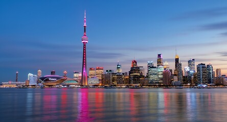 Obraz premium Stunning Night Skyline Cityscape, Tower, and Waterfront Reflection