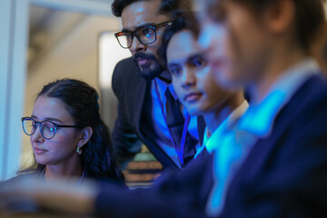 An Indian business manager leads his diverse team, analyzing critical market data on a screen. Intense focus on financial strategy and corporate decision making in a modern office.