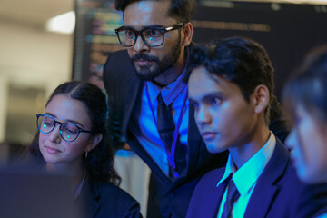 A senior AI architect mentors a diverse team as they debug a complex neural network. Intense,...