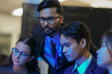 A senior AI architect mentors a diverse team as they debug a complex neural network. Intense, focused collaboration on developing the future of Artificial General Intelligence (AGI).