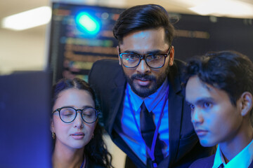 An Indian business manager leads his diverse team, analyzing critical market data on a screen. Intense focus on financial strategy and corporate decision making in a modern office.