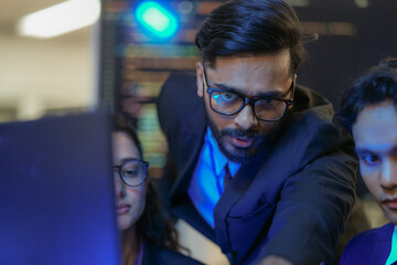 A senior AI architect mentors a diverse team as they debug a complex neural network. Intense,...