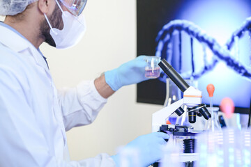 A diverse team of scientists collaborates in a high-tech biotech lab. A senior researcher mentors...