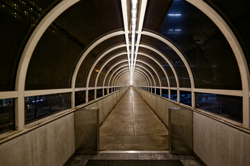 Futuristic Tunnel Walkway at Night with Geometric Symmetry and Vanishing Point Perspective