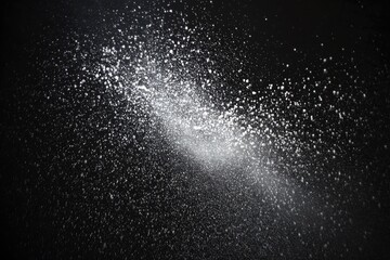 Abstract spread of light-gray particles against a dark background