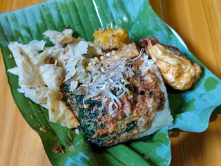 Nasi pecel or sego pecel is a typical Javanese Indonesian rice dish served with pecel sauce, which...