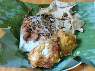 Nasi pecel or sego pecel is a typical Javanese Indonesian rice dish served with pecel sauce, which...