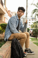 Modern lifestyle captured in casual setting. Colombian man in an urban garden, surrounded by plants...
