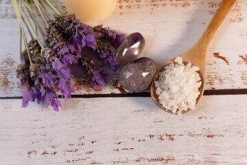 Top view of white table with lavender flowers near quartz and salt