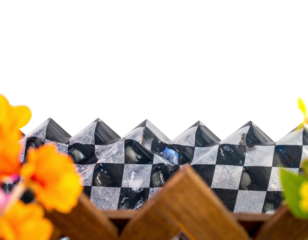 Decorative black and silver checkered border with a wavy pyramidal top edge and textured squares.