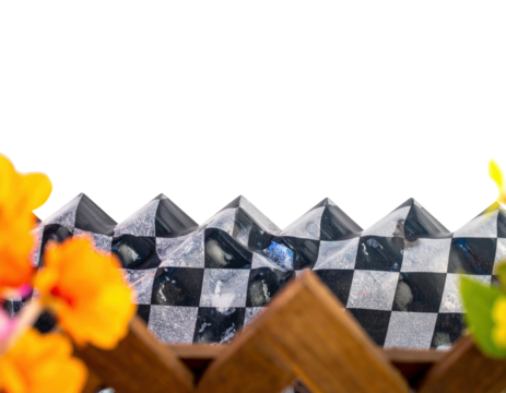 Decorative black and silver checkered border with a wavy pyramidal top edge and textured squares.