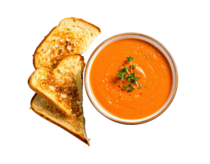 Bowl of creamy tomato soup with thyme and pepper served with a toasted grilled cheese sandwich.