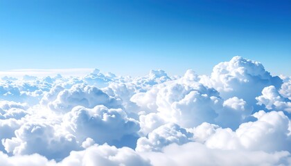 High-altitude view of fluffy white clouds against a vibrant blue sky