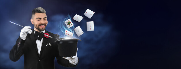 Male magician showing tricks with hat on white background