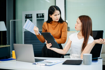A stressed business team in shock after financial failure. Upset colleagues brainstorm solutions,...