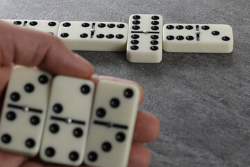 hand with domino effect on white