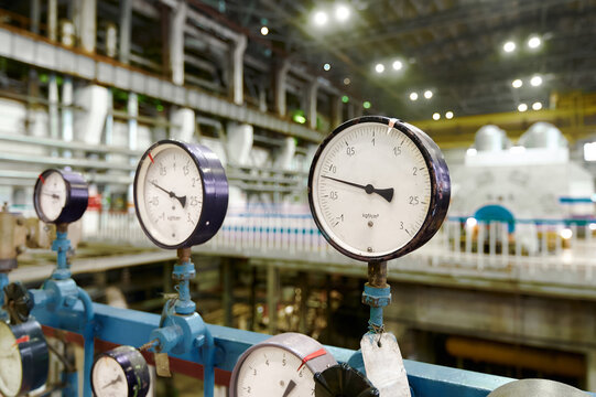 Detailed analog pressure gauge setup in an industrial facility showing precise measurements and equipment - Powered by Adobe