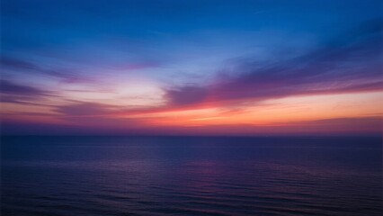 Obraz premium Serene Sunset Over the Ocean with Vibrant Sky Colors