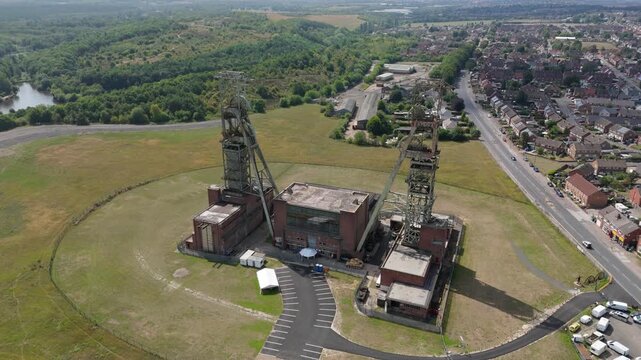 Aerial drone view of coal colliery mine site, industrial revolution legacy infrastructure extracting energy materials from earth Clipstone, Notttingham, England. 