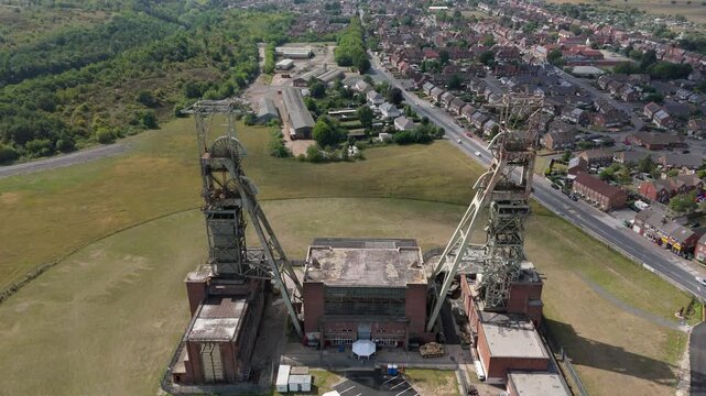 Aerial drone view of coal colliery mine site, industrial revolution legacy infrastructure extracting energy materials from earth Clipstone, Notttingham, England. 