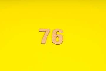 Number seventy-six on yellow background