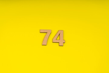 Number seventy-four on yellow background