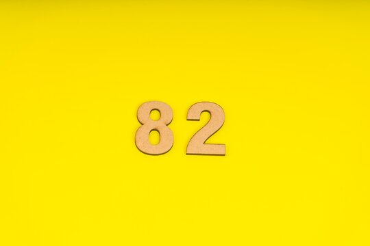 Number eighty-two on yellow background