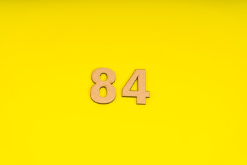 Number eighty -our on yellow background