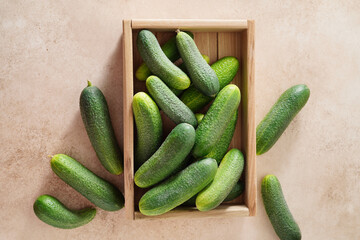 Fresh cucumbers in wooden box. Top view.