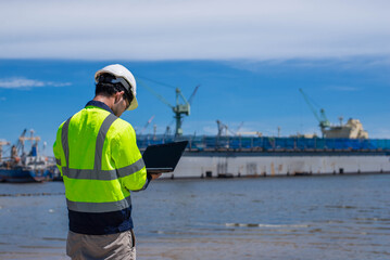 A skilled architect is examining the structure of a pier.