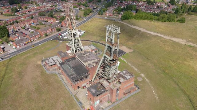 Aerial drone view of coal colliery mine site, industrial revolution legacy infrastructure extracting energy materials from earth Clipstone, Notttingham, England. 