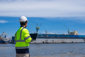 A skilled architect is examining the structure of a pier.